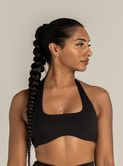 Sculpt Halter Bra in Carbon, a black halter neck sports bra, front view on a model