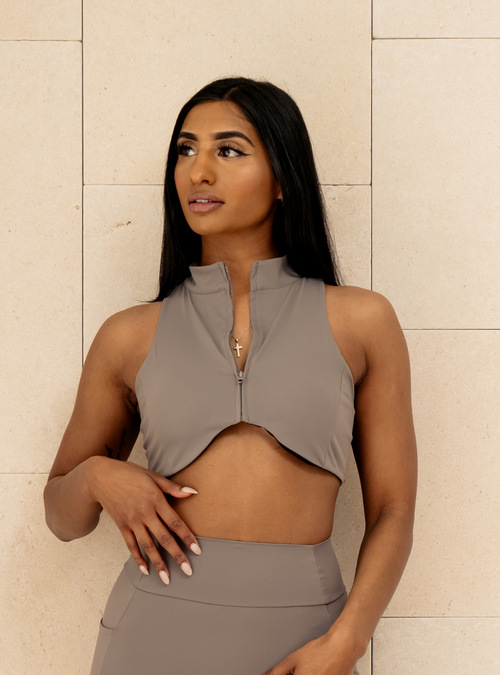 Sculpt Zip Crop in Tarmac, a taupe grey sleeveless zip crop top, front view on a model
