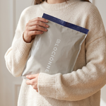 Holding a sealed Lociónne mystery bag
