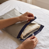 Opening a Lociónne mystery bag on a bed