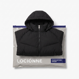 Cloud Puffer Carbon folded on the Lociónne mystery bag mailer, guaranteed inside every Premium Mystery Bag